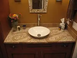 Tile countertop in the bathroom under the sink photo