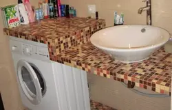 Tile countertop in the bathroom under the sink photo