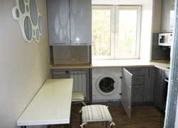 Photo Of A Kitchen With A Refrigerator, Washing Machine And Gas Stove