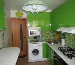 Photo of a kitchen with a refrigerator, washing machine and gas stove