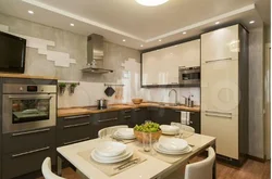 Corner kitchen design with refrigerator and TV photo