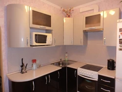 Corner kitchen design with refrigerator and TV photo