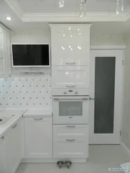 Kitchen with white appliances in the interior photo