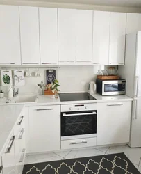 Kitchen with white appliances in the interior photo