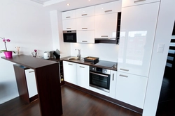 Kitchen with white appliances in the interior photo