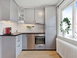 Design of a small kitchen with a refrigerator by the window