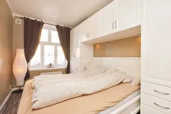 Photo of a small bedroom with a bed