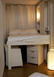 Photo of a small bedroom with a bed