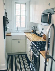 Design of a narrow kitchen in a house with a window