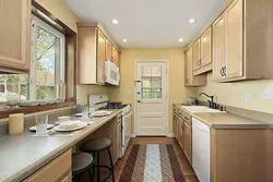 Design of a narrow kitchen in a house with a window