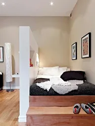 Room in a studio apartment with a bed photo