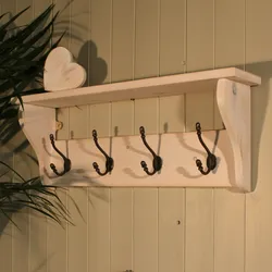 Clothes hangers in the hallway made of wood photo