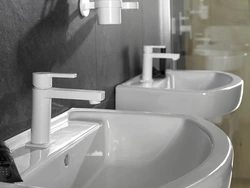 White faucets in the bathroom interior