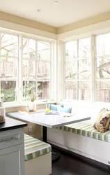 Table by the window in a small kitchen with your own photos