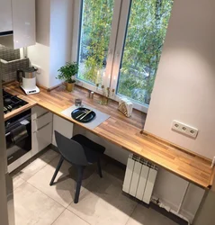 Table by the window in a small kitchen with your own photos