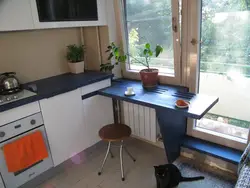 Table by the window in a small kitchen with your own photos