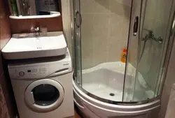 Bathroom with shower and washing machine with sink photo