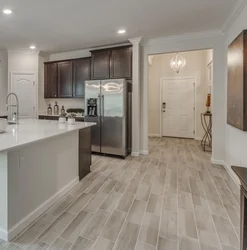 Laminate In The Living Room And Tiles In The Kitchen Photo