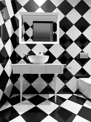 Bathtub made of white and black tiles in the bathroom photo
