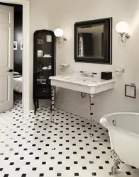 Bathtub made of white and black tiles in the bathroom photo