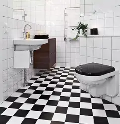 Bathtub Made Of White And Black Tiles In The Bathroom Photo