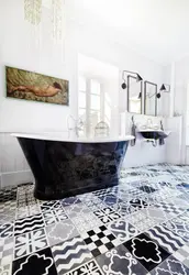 Bathtub Made Of White And Black Tiles In The Bathroom Photo