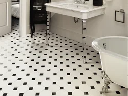 Bathtub made of white and black tiles in the bathroom photo