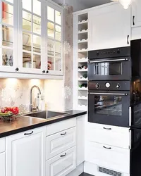 White kitchen black appliances in the interior