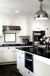 White kitchen black appliances in the interior