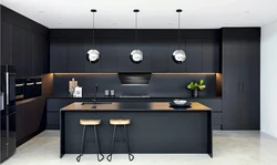 Gray kitchen with dark countertops in the interior photo