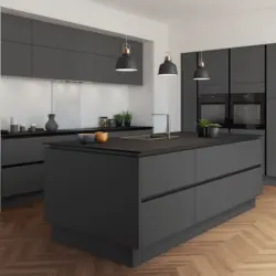 Gray kitchen with black countertop and apron in the interior