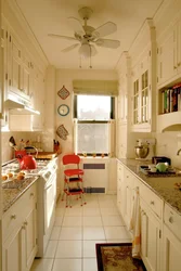 Design of a narrow kitchen with a window on the entire wall