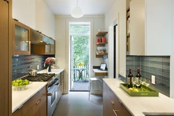 Design of a narrow kitchen with a window on the entire wall