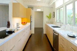 Design of a narrow kitchen with a window on the entire wall