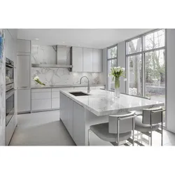 White kitchen with marble countertop and apron in the interior