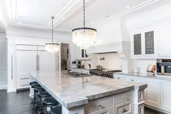White kitchen with marble countertop and apron in the interior