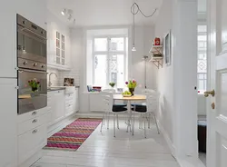 White walls and white floor in the kitchen interior