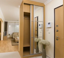 Wardrobe in a small hallway with a mirror photo