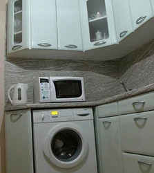 Kitchens with a washing machine under the countertop corner photo