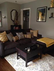 Living room with dark sofa design photo