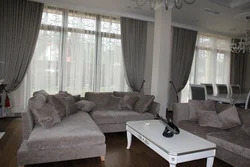 Living room design with gray sofa and curtains