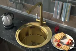 Golden sink in the kitchen interior