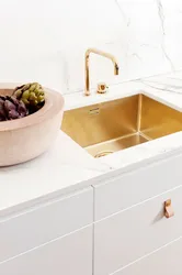 Golden sink in the kitchen interior