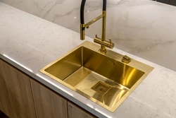 Golden sink in the kitchen interior