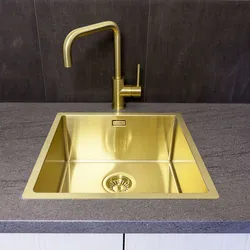 Golden sink in the kitchen interior