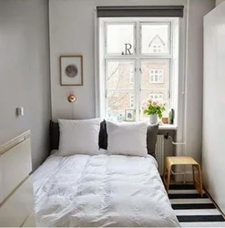 Interior of a narrow bedroom with one window