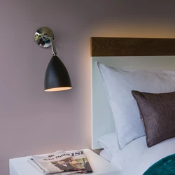 Wall sconce in the bedroom above the bed photo