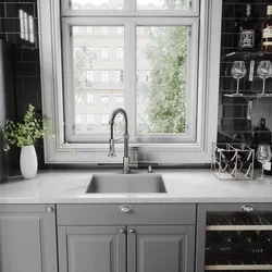 Kitchen design by the window with a sink in the apartment
