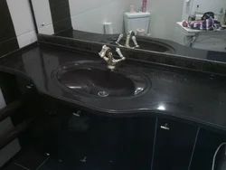 Sink in a stone countertop in a bathroom photo