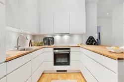 White set with a wooden countertop in the kitchen interior